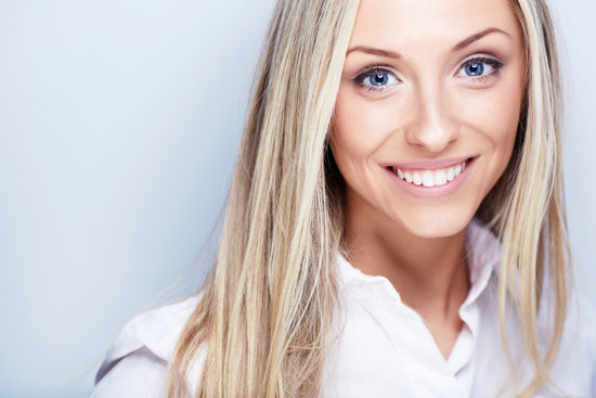 Smiling young woman in white shirt