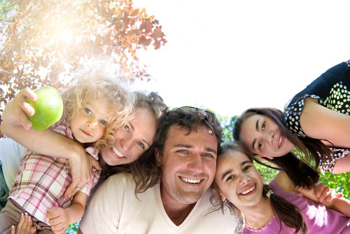 Happy family having fun in summer park